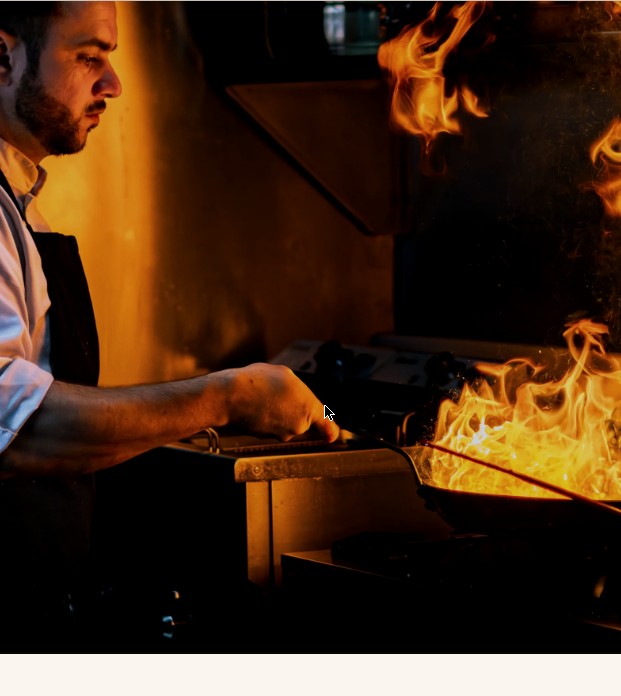 Chef working over open flame